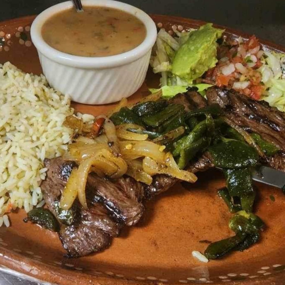 El Centenario WPB's carne asada with rice, beans, grilled peppers, onions, and pico de gallo.
